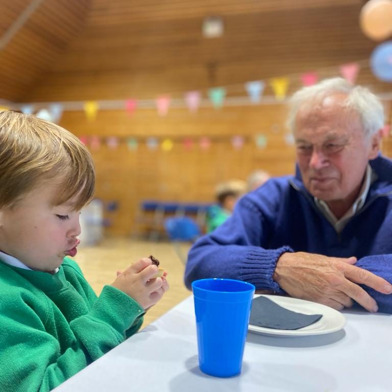 child sitting with his granddad